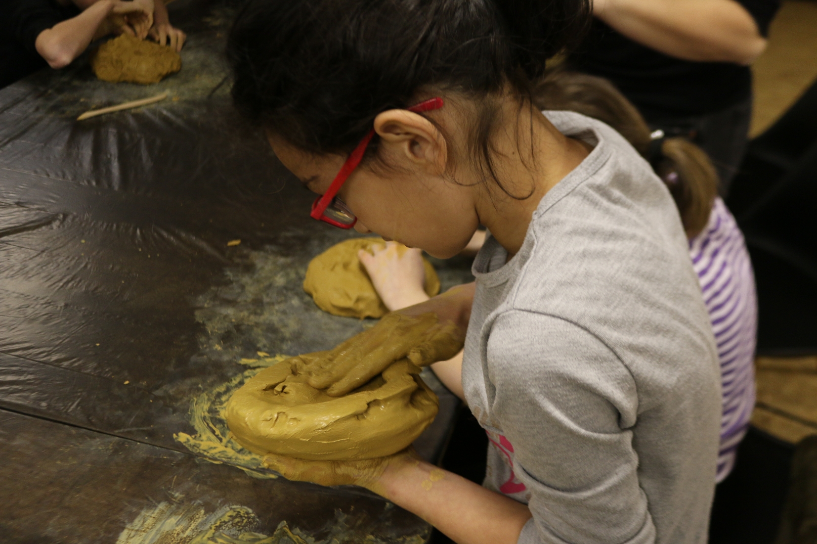 A girl sculpting clay