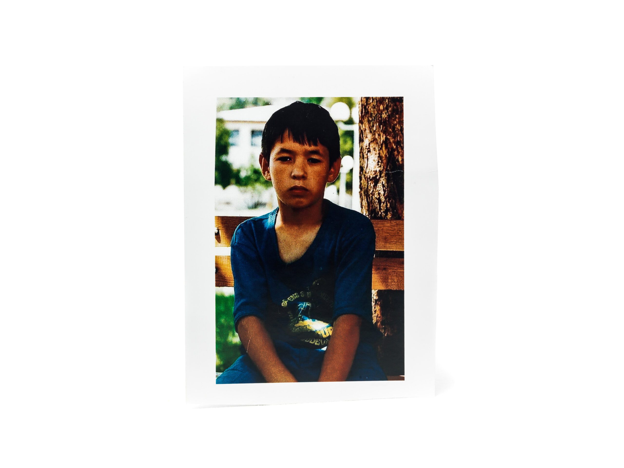 Photo of a brooding boy in blue t-shirt