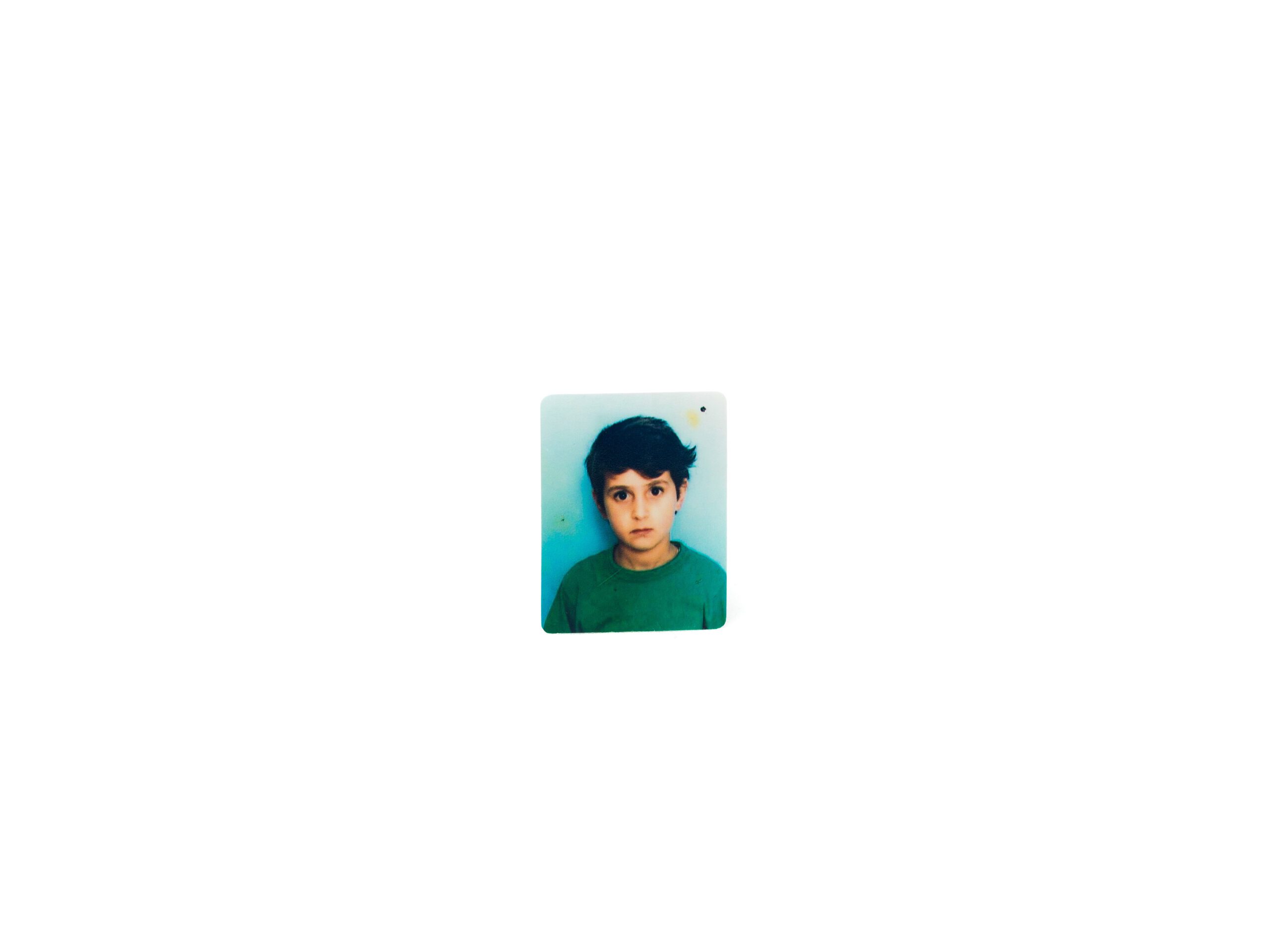 Small photo of a girl with short haircut in green shirt